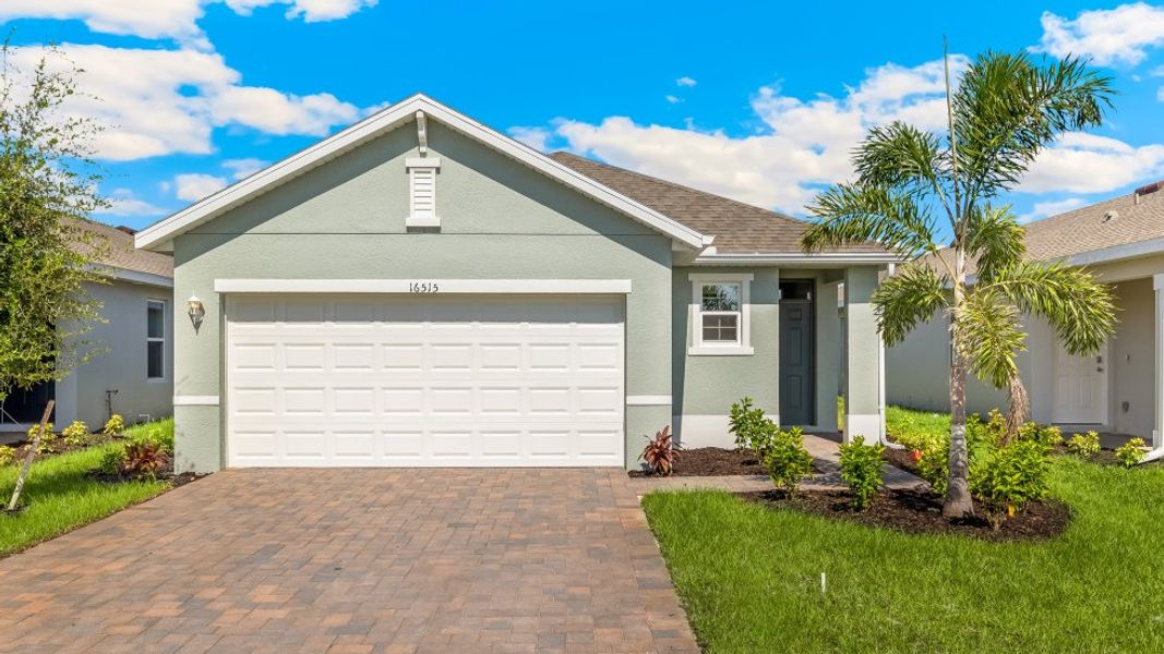 Front exterior of a new home in Bentley Crossing, Fort Myers, FL, highlighting curb appeal (Image 1).