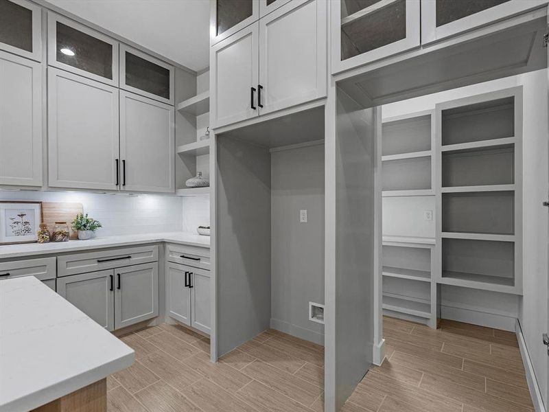 This kitchen features a hidden walk in pantry next to the fridge