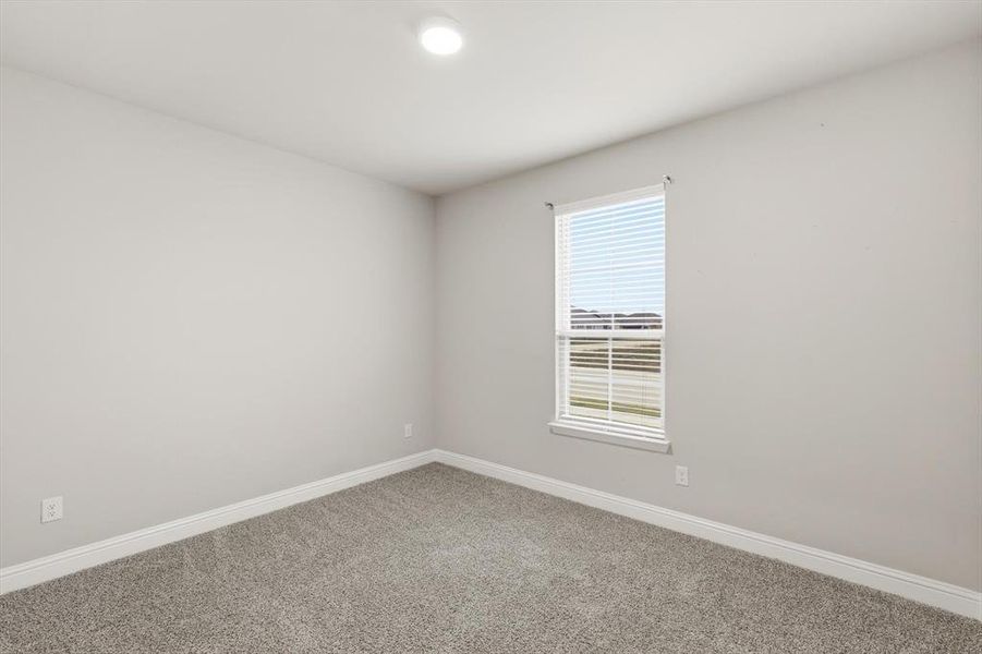 Spare room with baseboards and carpet
