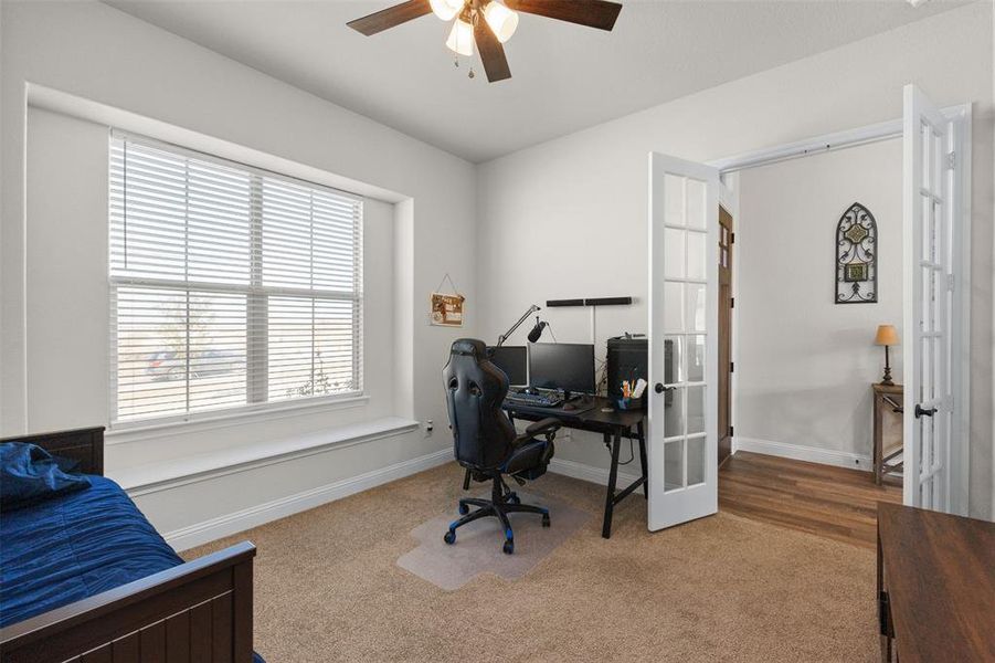Office space with ceiling fan, carpet, and french doors Office space with ceiling fan, carpet, and french doors