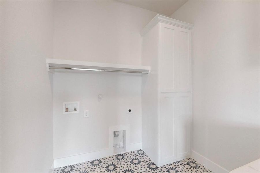 Clothes washing area with washer hookup, cabinets, hookup for an electric dryer, and gas dryer hookup