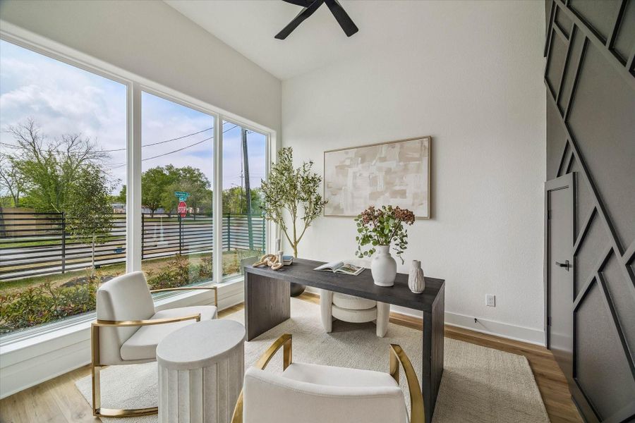 Your creative juices will be flowing in the fist floor home office. Large windows, accent wall, modern fan and so much more accentuates your work space