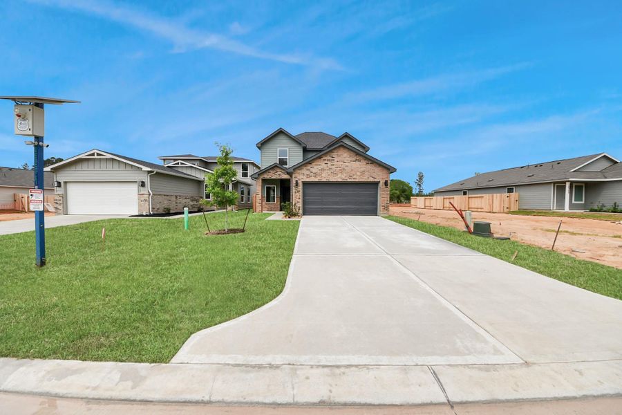 Front exterior of a new home in The Enclave at Spring Branch, Montgomery, TX, highlighting curb appeal (Image 24). Front exterior of a new home in The Enclave at Spring Branch, Montgomery, TX, highlighting curb appeal (Image 24).