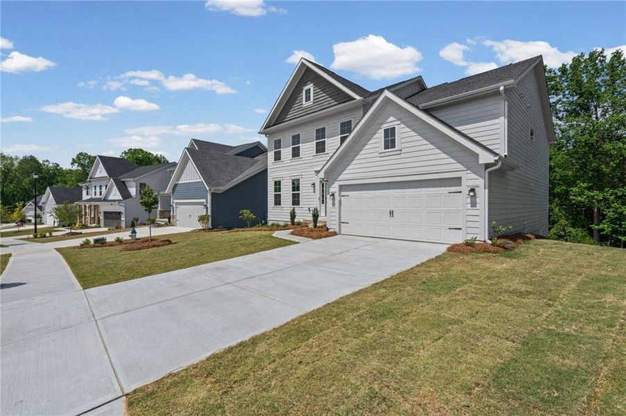 Front exterior of a new home in The Reserve At Liberty Park, Braselton, GA, highlighting curb appeal (Image 2). Front exterior of a new home in The Reserve At Liberty Park, Braselton, GA, highlighting curb appeal (Image 2).