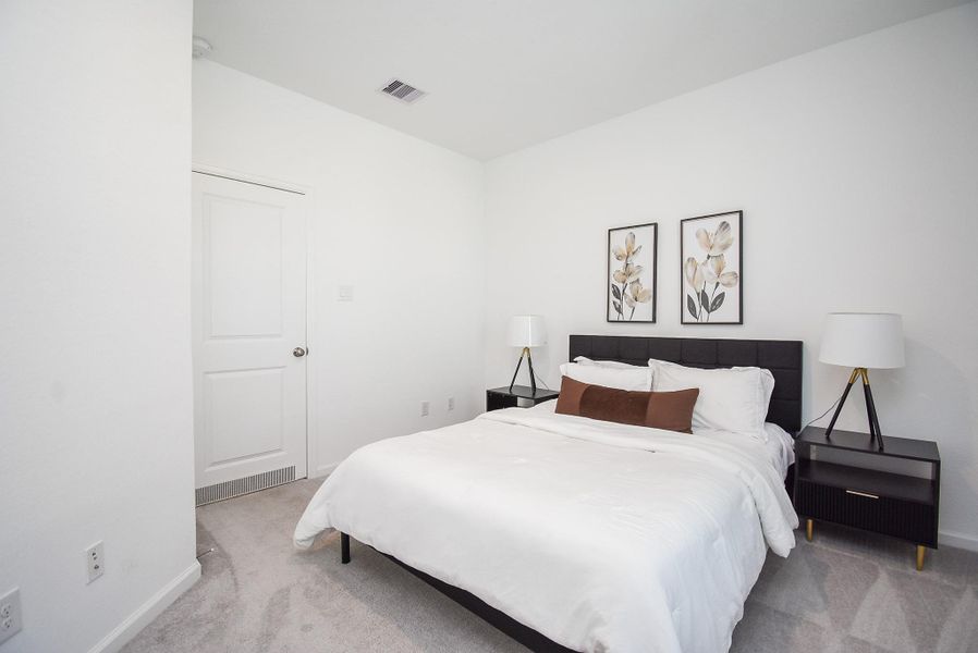 A cozy guest bedroom with neutral tones and ample space for comfort.