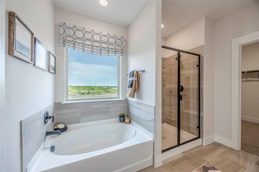 Bathroom with separate shower and tub and tile patterned flooring