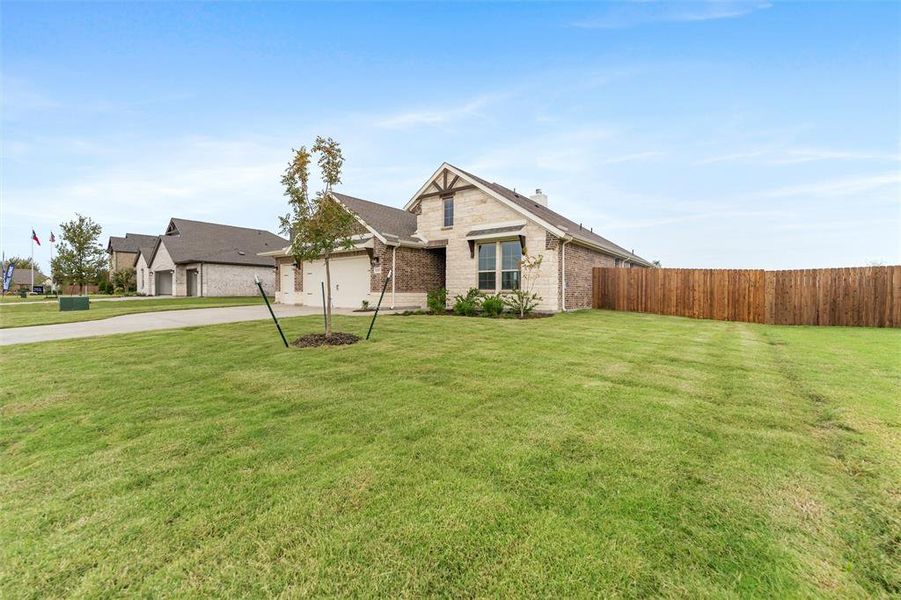 View of front of property featuring driveway, a chimney, and brick siding View of front of property featuring driveway, a chimney, and brick siding
