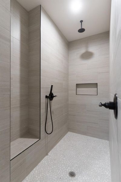 Full bath featuring tiled shower