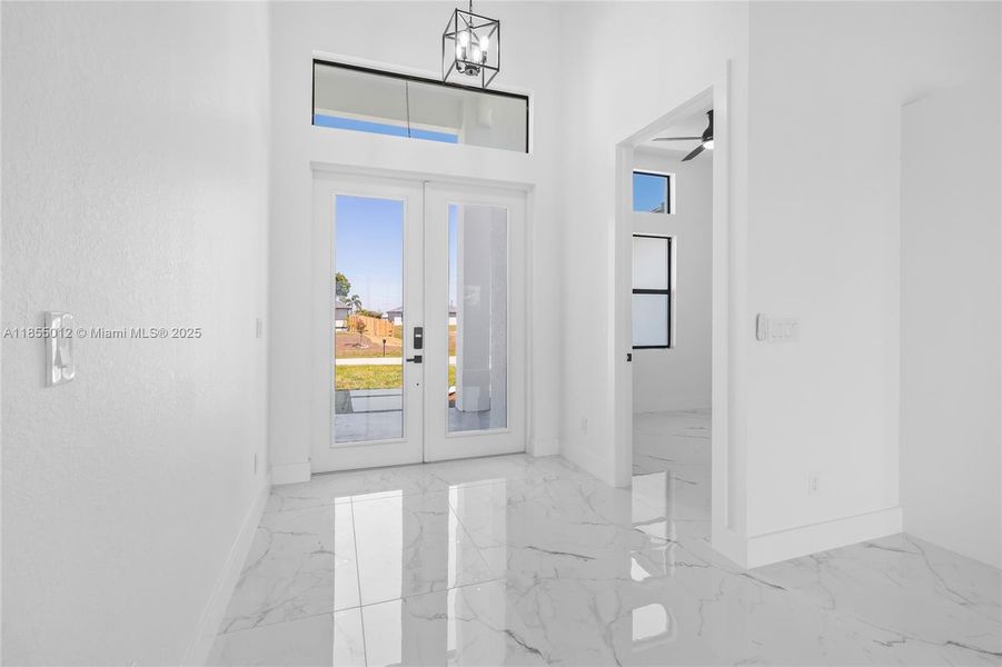 Foyer Entrance with marble finish floor with French doors