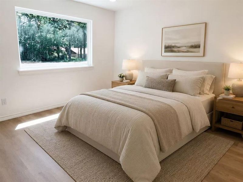 Expansive window with white trim, wood-finish flooring, white walls, and a light-colored area rug Expansive window with white trim, wood-finish flooring, white walls, and a light-colored area rug