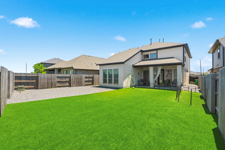 Expansive backyard offering plenty of room for outdoor activities and entertaining and featuring low-maintenance turf, providing a beautiful green space year-round and an ideal area for pets to play and enjoy the outdoors