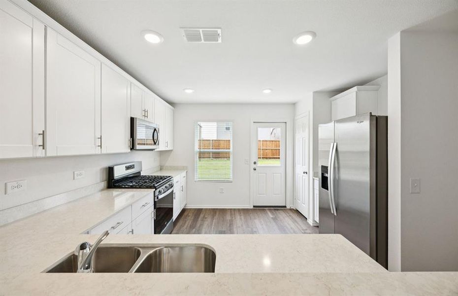 Spacious kitchen with access to backyard