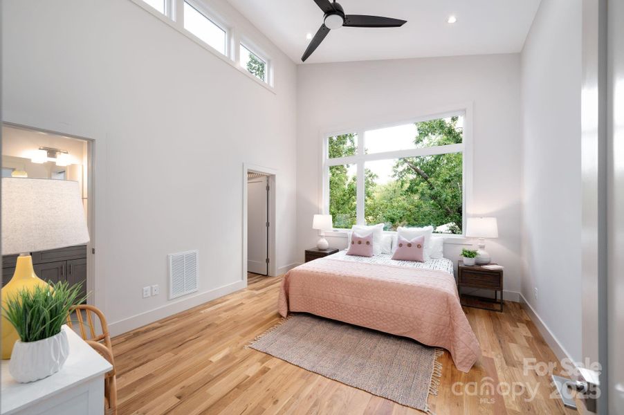 Lux Primary Suite Features a Vaulted Ceiling and Treetop View Lux Primary Suite Features a Vaulted Ceiling and Treetop View