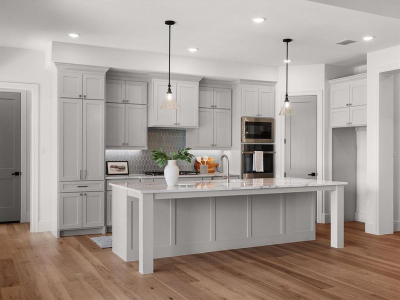Kitchen featuring tasteful backsplash, light wood-type flooring, stainless steel appliances, recessed lighting, and a center island with sink