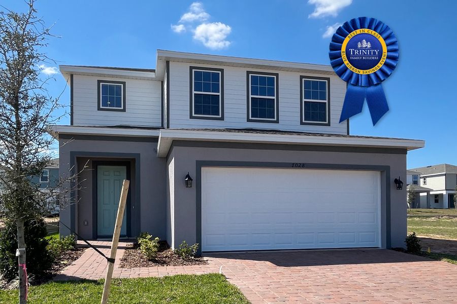 Front exterior of a new home in Trinity Lakes, Groveland, FL, highlighting curb appeal (Image 2).
