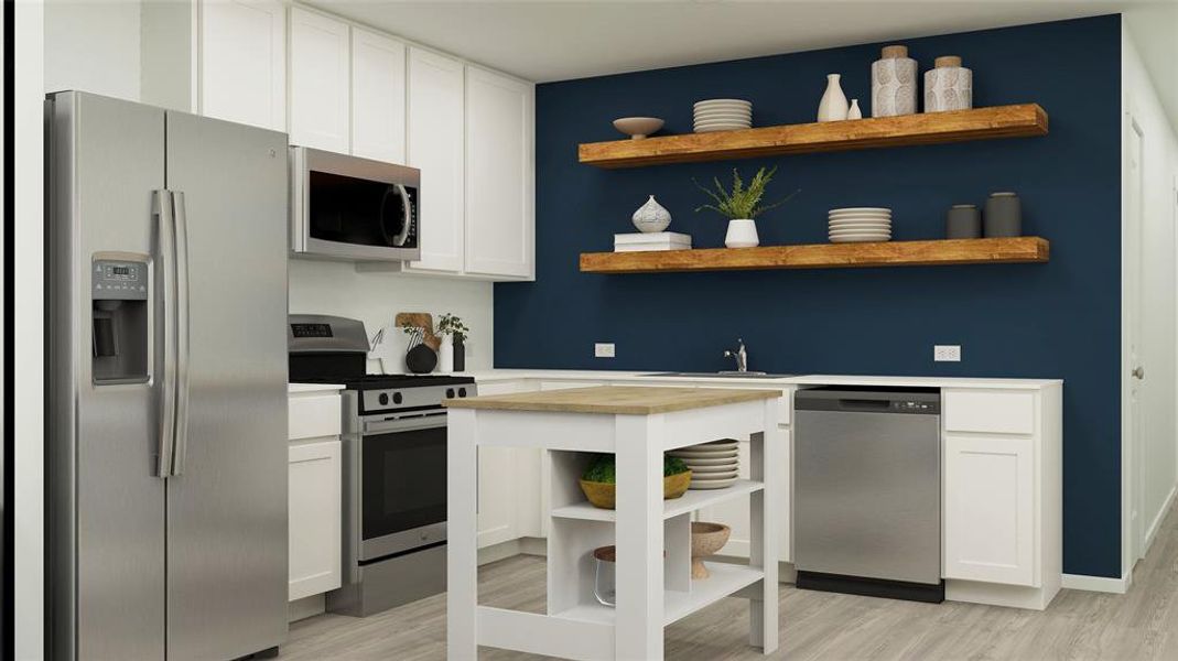 Kitchen featuring white cabinetry, light hardwood / wood-style flooring, and stainless steel appliances