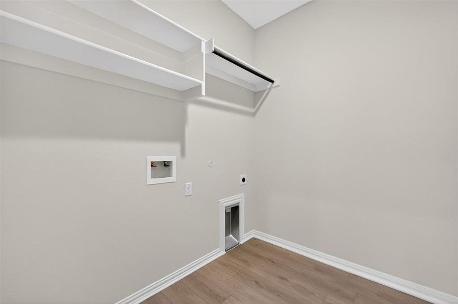 Laundry room with gas dryer hookup, light wood-style floors, hookup for an electric dryer, and hookup for a washing machine