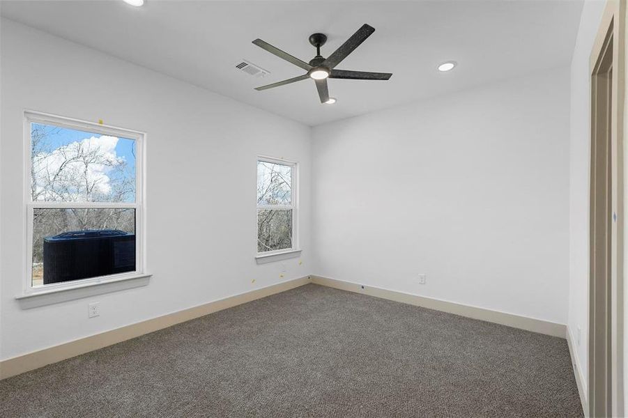 Unfurnished room featuring visible vents, recessed lighting, carpet floors, baseboards, and ceiling fan