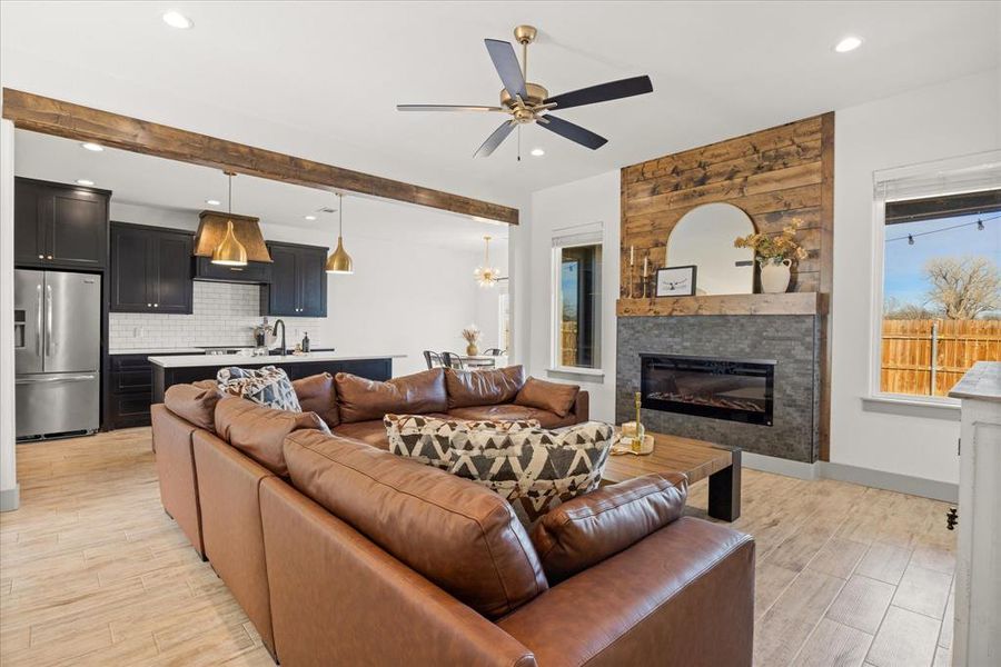 Beautiful living room, open to the kitchen, with a fireplace for cozy vibes. Beautiful living room, open to the kitchen, with a fireplace for cozy vibes.