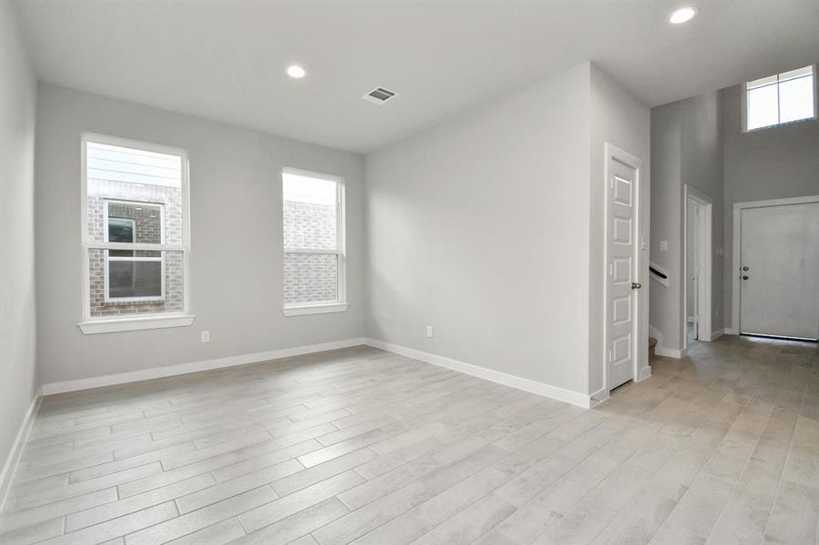 Dedicated dining space seamlessly woven into the open concept, connecting the family room and kitchen. Revel in the stunning floors and soothing paint palette.