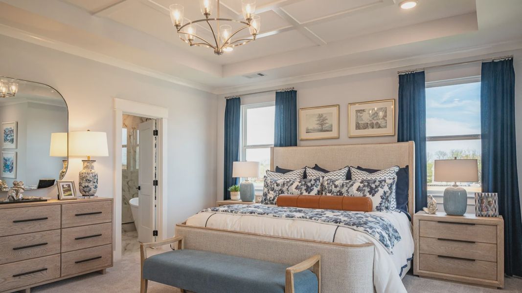 Oversized bedroom with accent trim tray ceiling, and king-sized bed