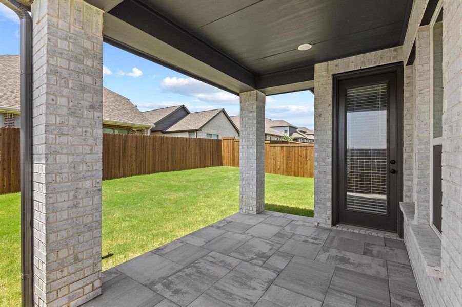 The Covered Backyard Patio is the Perfect Spot to Grill and Entertain
