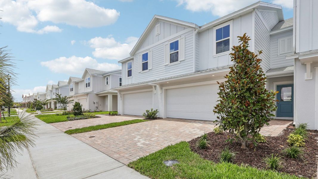 Front exterior of a new home in Cyrene at Harmony, St. Cloud, FL, highlighting curb appeal (Image 2).