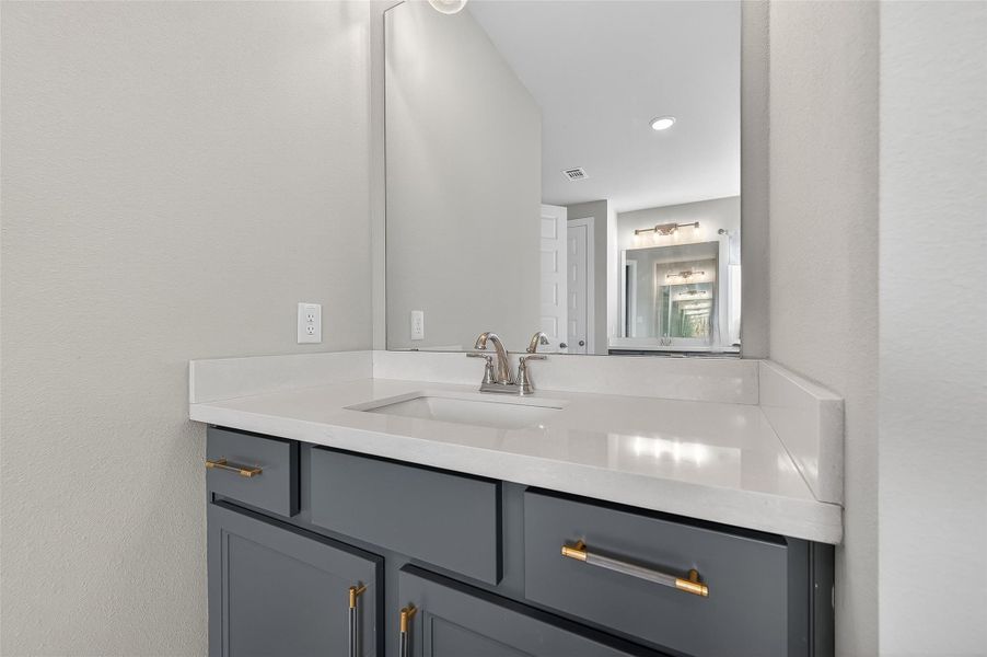 Crisp lines, premium finishes, and a soft color palette elevate this well-appointed vanity area. Ideal for personal prep or sharing the space in style.