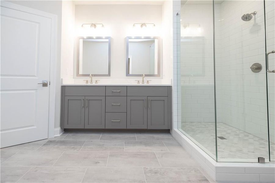 The primary bathroom features a double vanity.*Please note photos shown are of the Ellington plan but not of the actual home.