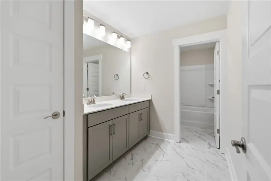 An elegant bathroom features a double vanity and s