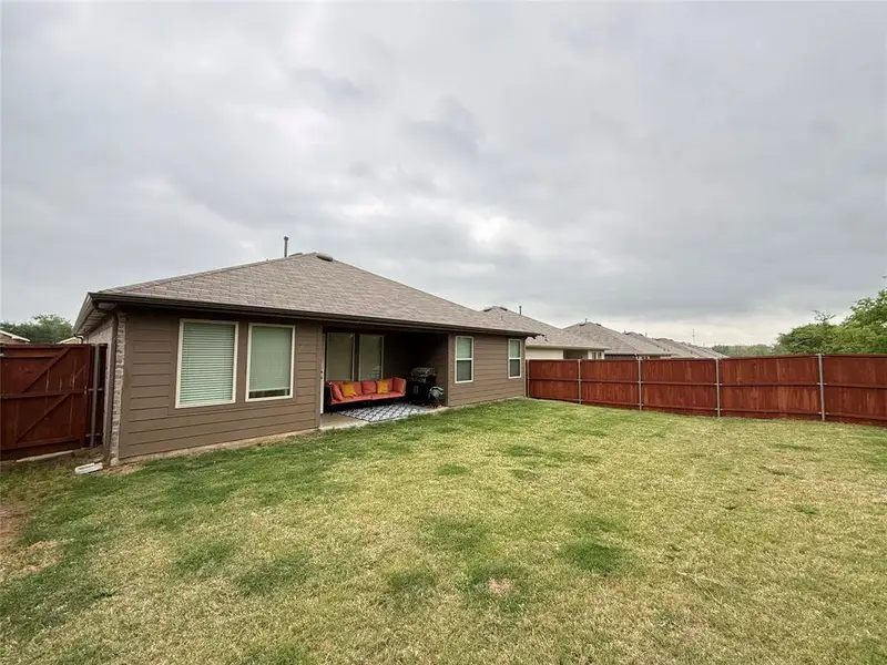 Exterior details and patio area of a home in Three Oaks, Sherman (Image 20).