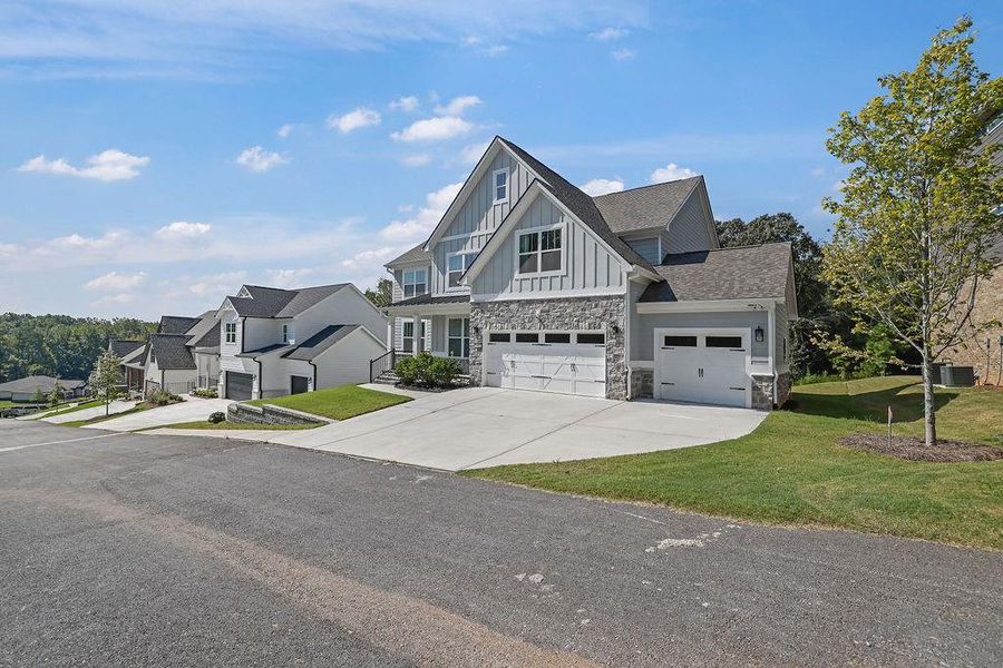 Front exterior of a new home in , Flowery Branch, GA, highlighting curb appeal (Image 22).