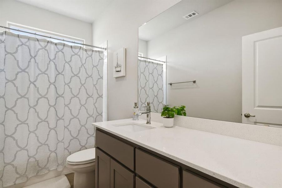 Bathroom with vanity and shower / bath combo