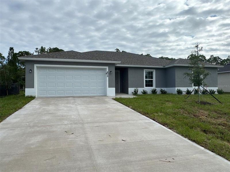 Front exterior of a new home in , Palm Bay, FL, highlighting curb appeal (Image 1).