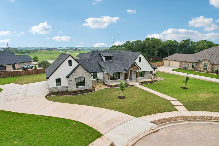Front exterior of a new home in , Salado, TX, highlighting curb appeal (Image 25). Front exterior of a new home in , Salado, TX, highlighting curb appeal (Image 25).
