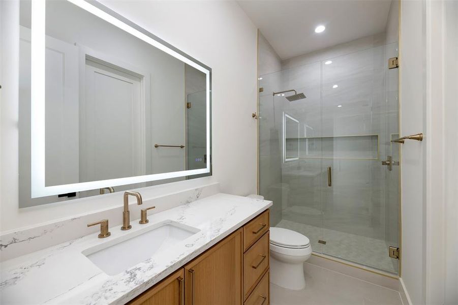 Full bath with a stall shower, vanity, light tile patterned flooring, and recessed lighting Full bath with a stall shower, vanity, light tile patterned flooring, and recessed lighting
