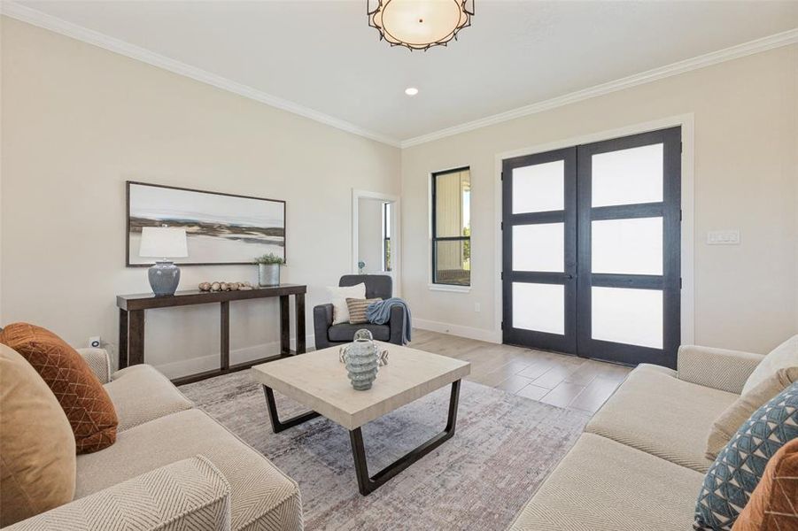 Living area featuring light-toned walls, crown molding, and wood-finish flooring