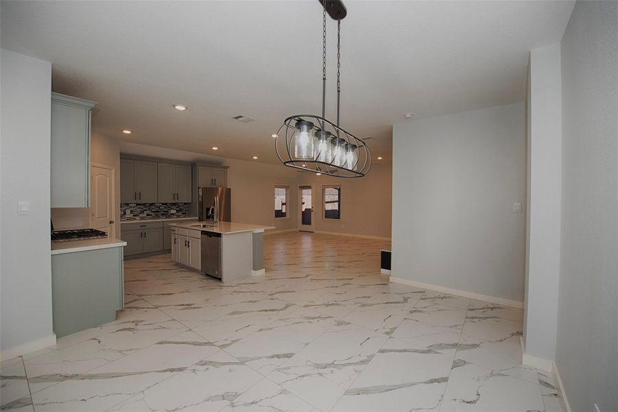 A view of the formal dining room open to both the kitchen and the family room. A view of the formal dining room open to both the kitchen and the family room.
