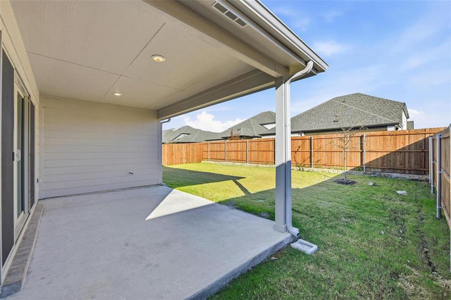 Fenced backyard featuring a patio