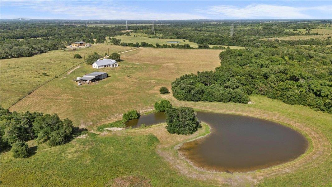 Aerial overview of property's location featuring rural landscape and a nearby body of water