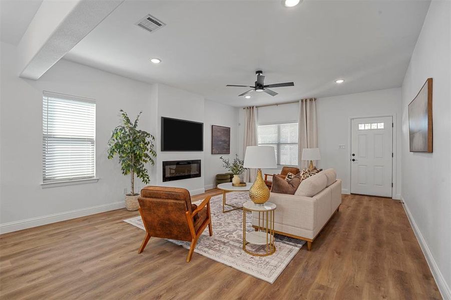 Living room featuring ceiling fan and hardwood / wood-style floors