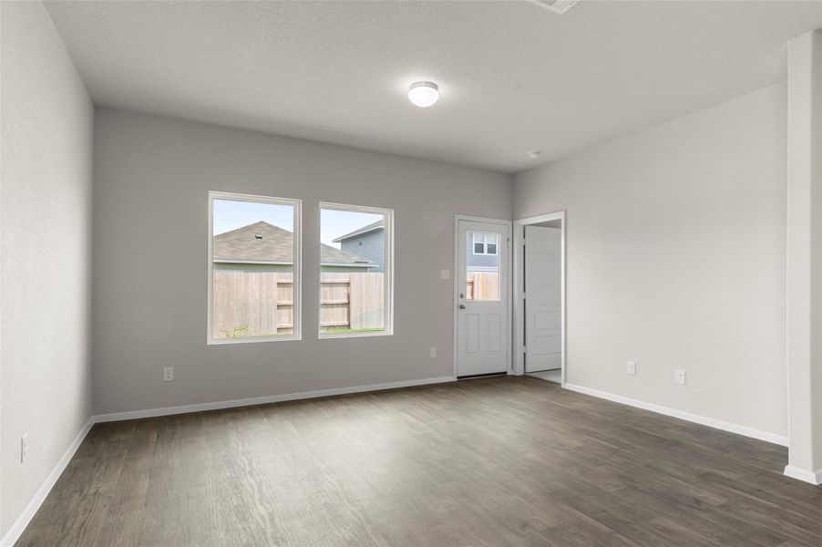 Spare room featuring dark wood-style flooring and baseboards Spare room featuring dark wood-style flooring and baseboards