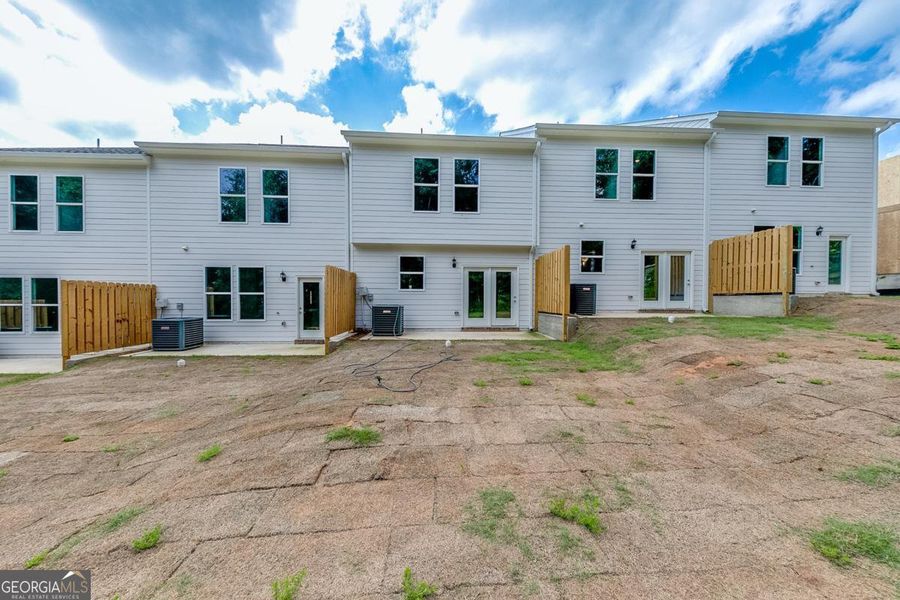 Exterior details and patio area of a home in Chimney Oaks Townhomes, Homer (Image 16).