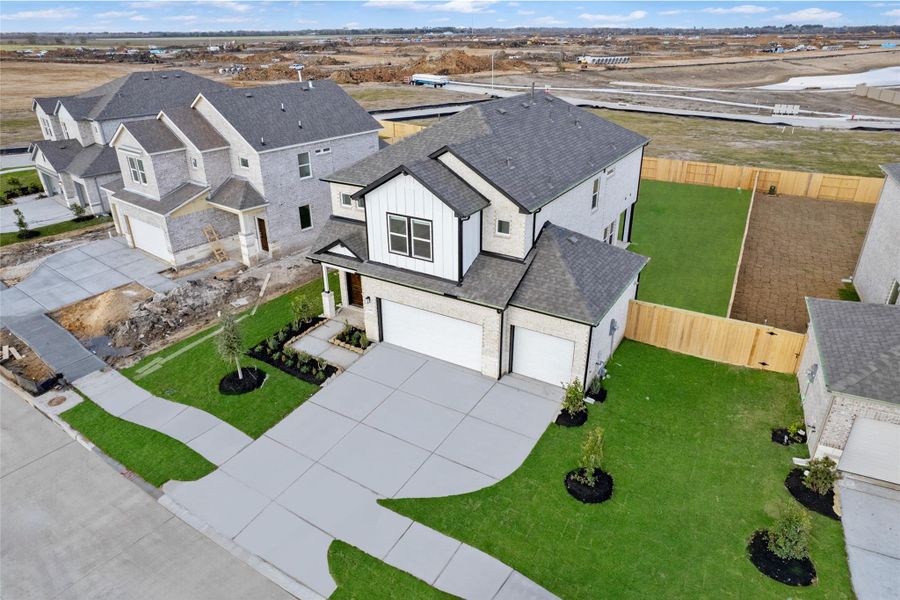 Front exterior of a new home in Creekhaven, Iowa Colony, TX, highlighting curb appeal (Image 20).