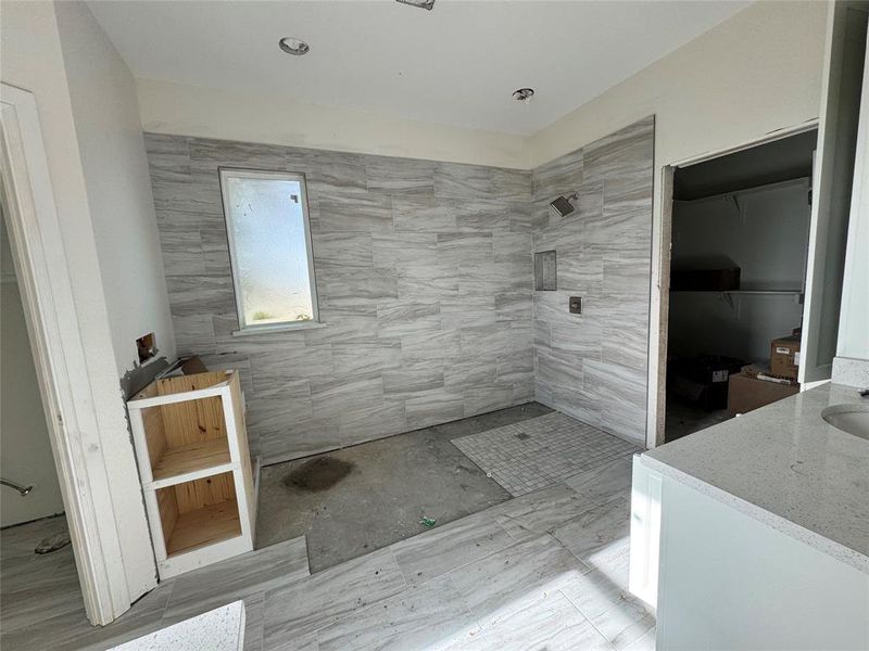 Bathroom with a tile shower and vanity