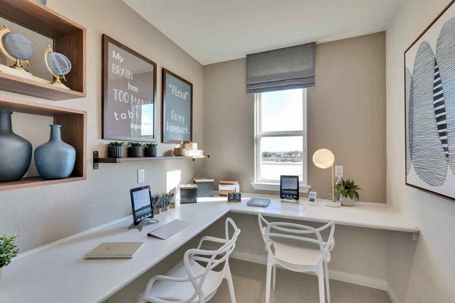 A well-lit, dedicated study zone with a large window and built-in desk offers a quiet place for productivity.