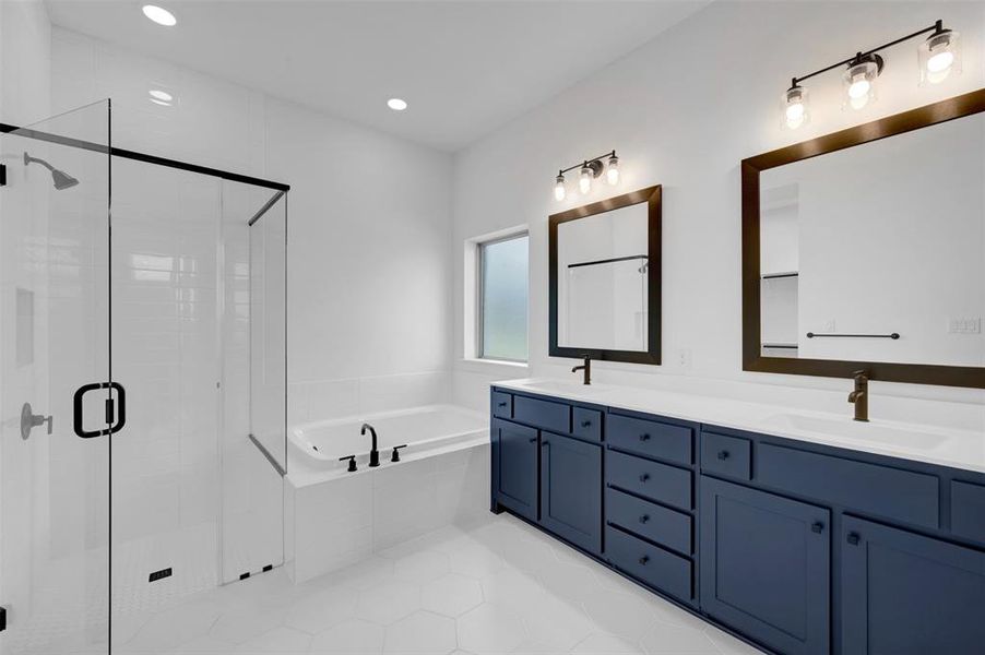 Full bathroom featuring double vanity, a stall shower, a bath, light tile patterned flooring, and recessed lighting
