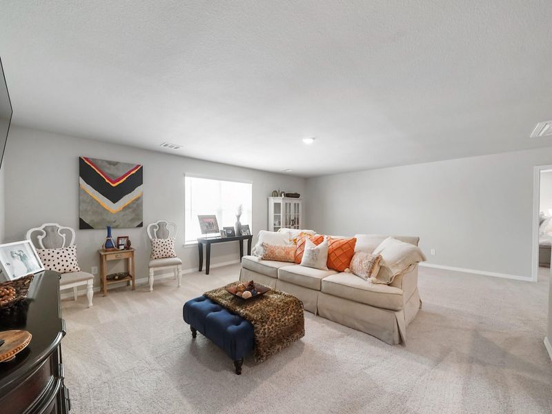 Bright and open, the game room is designed to accommodate a variety of uses while maintaining a comfortable, inviting atmosphere.