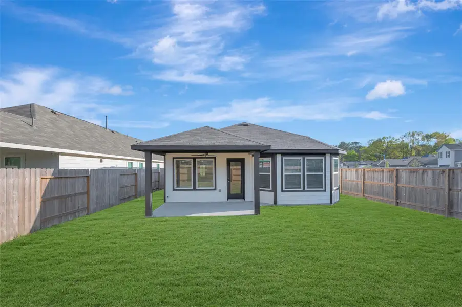 Exterior details and patio area of a home in Pinewood at Grand Texas, New Caney (Image 4).