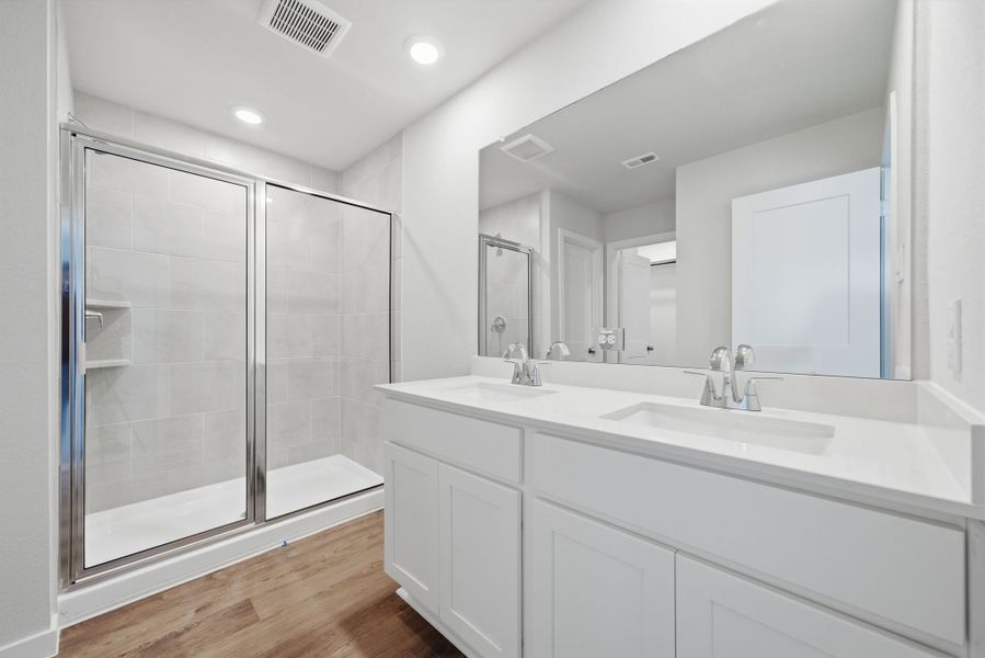 A bathroom with a glass shower. A bathroom with a glass shower.